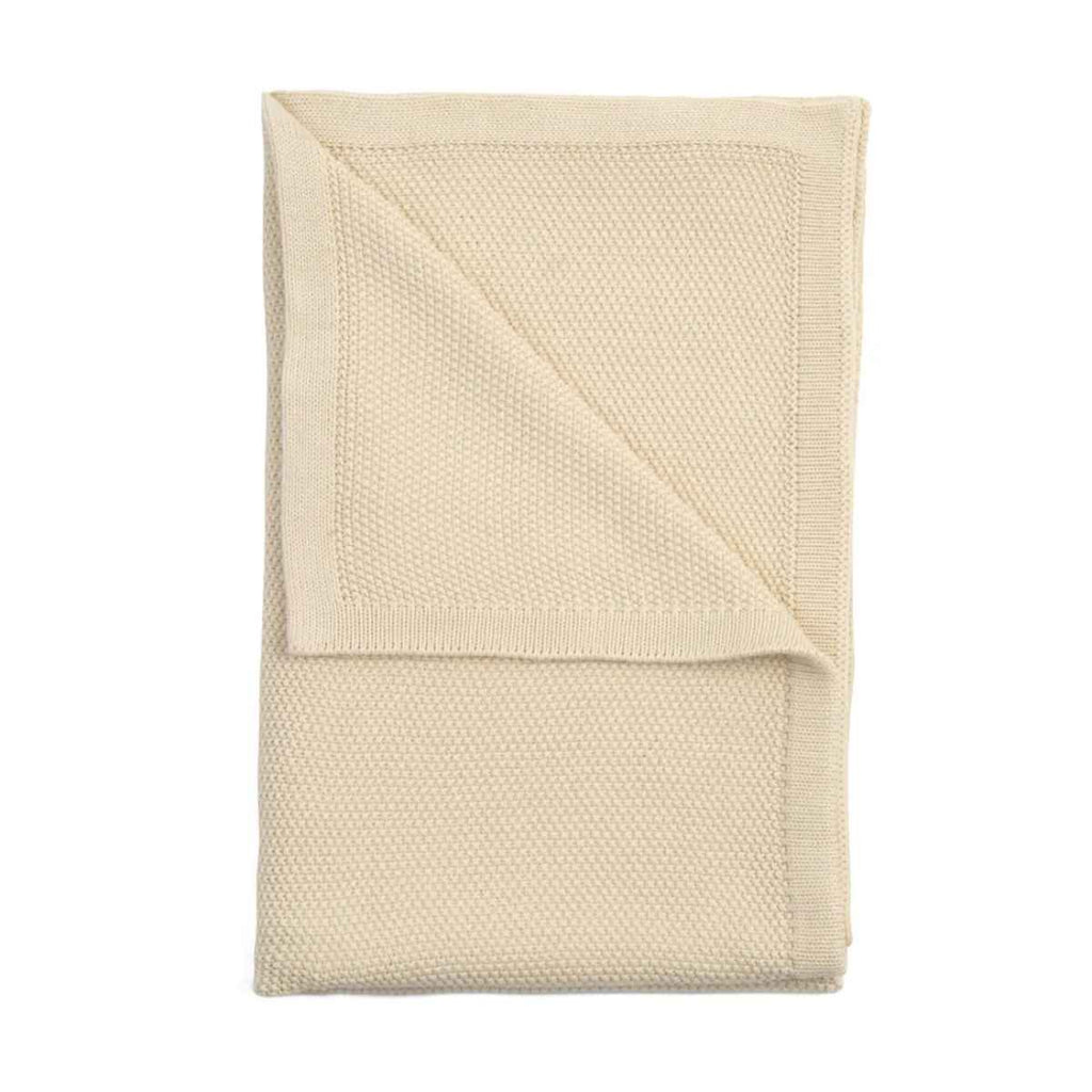 Cream knitted blanket on a white background