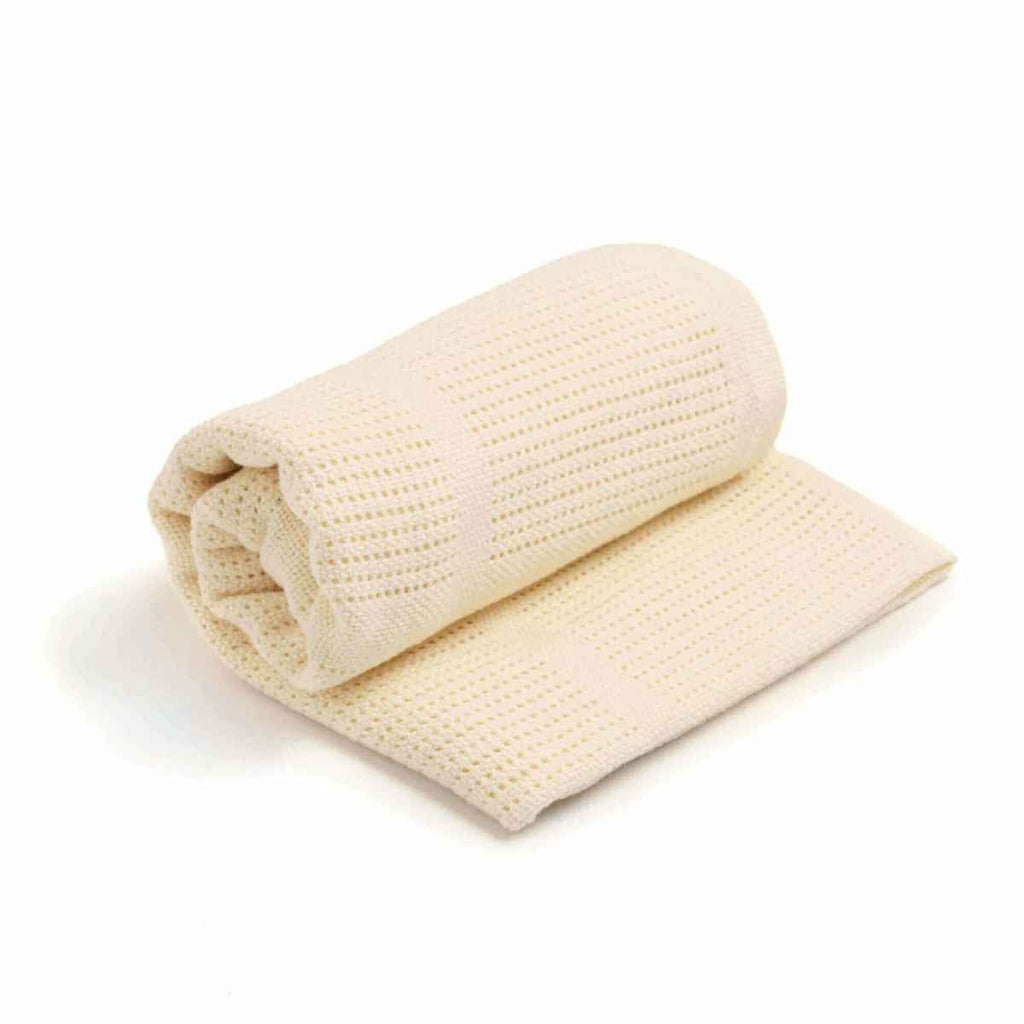 Rolled-up beige blanket on a white background