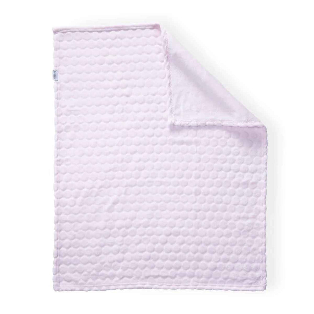 Quilted pink blanket on a white background