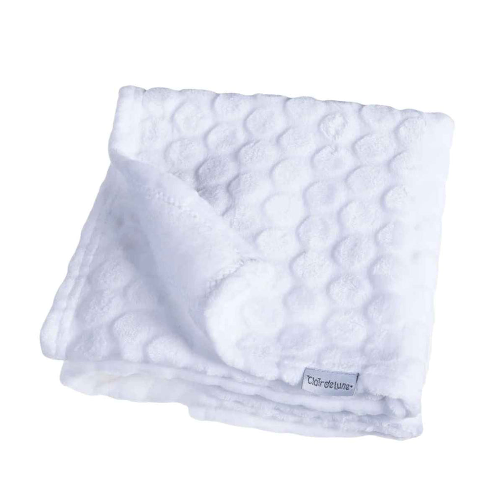White marshmallow textured blanket with Clair de Lune brand label on a white background