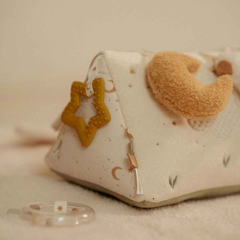 Baby activity triangle with star and moon design on a soft surface