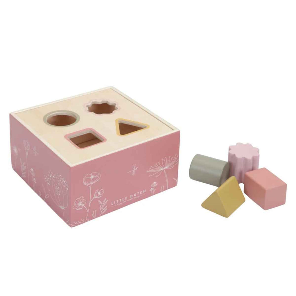 Pink wooden shape sorting toy with various geometric shapes on a white background