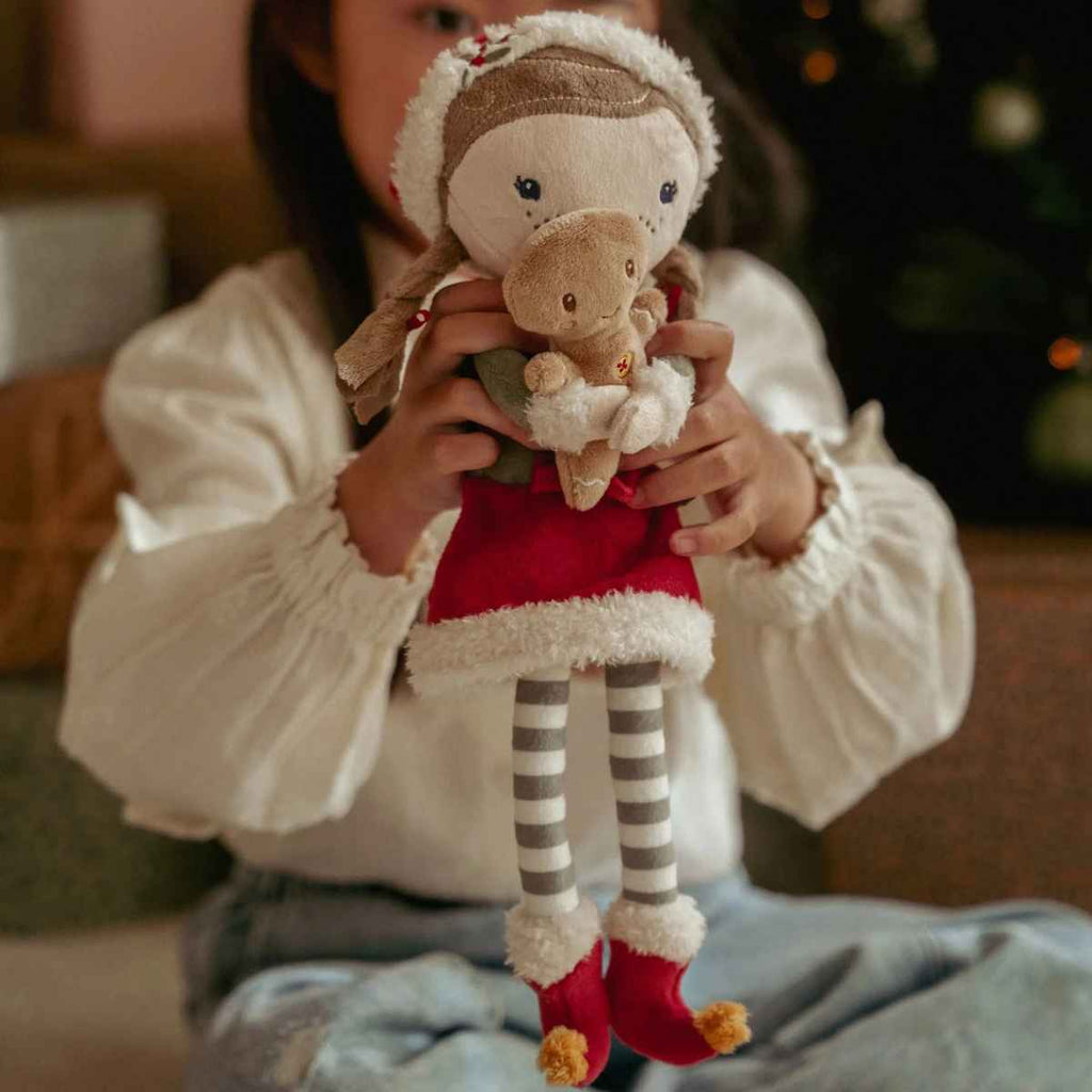 Person holding a plush toy with a Christmas theme.