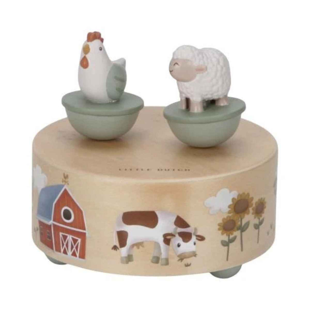 Wooden musical toy with farm animal figures on a white background