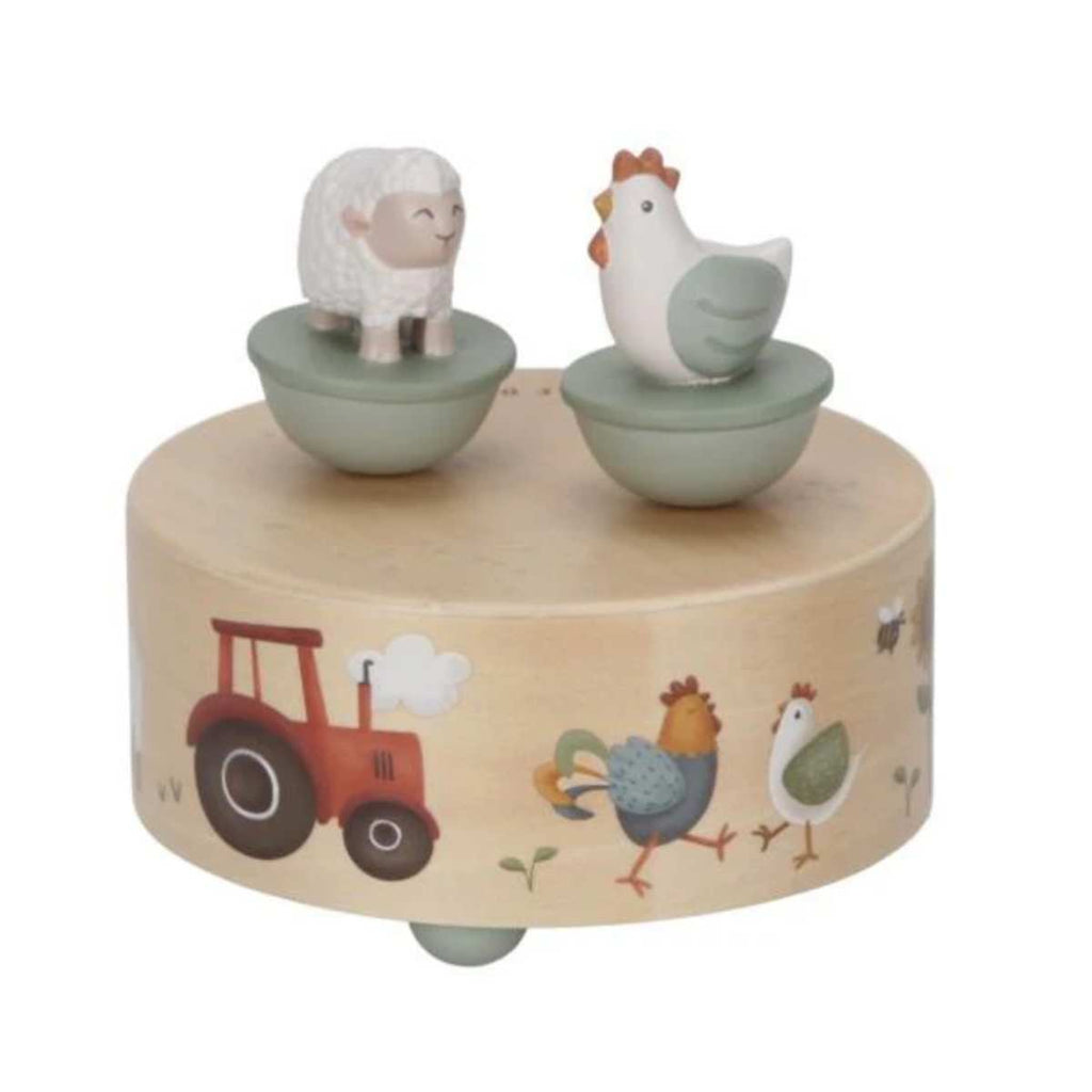 Wooden toy music box with painted farm images and a wooden chicken and sheep on top.
