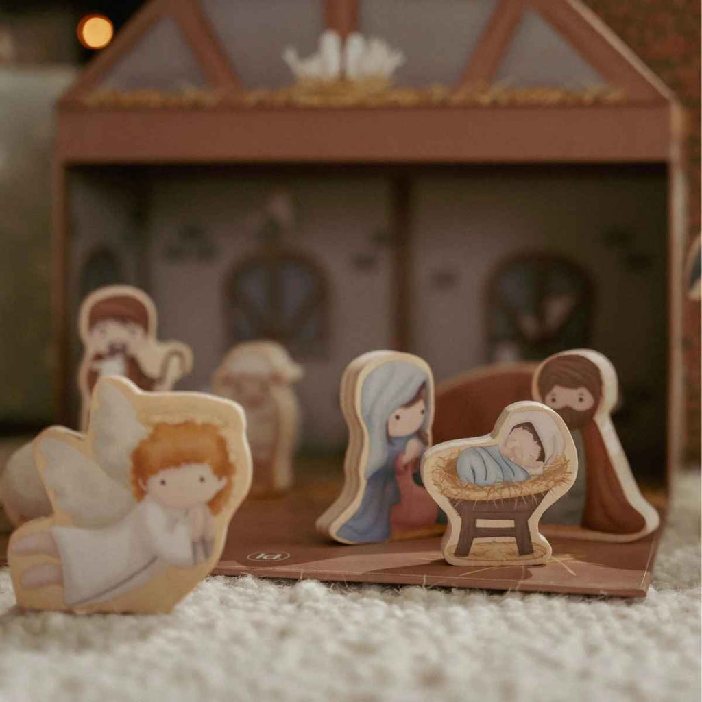 Wooden nativity scene with Mary, Joseph, and baby Jesus in a manger.