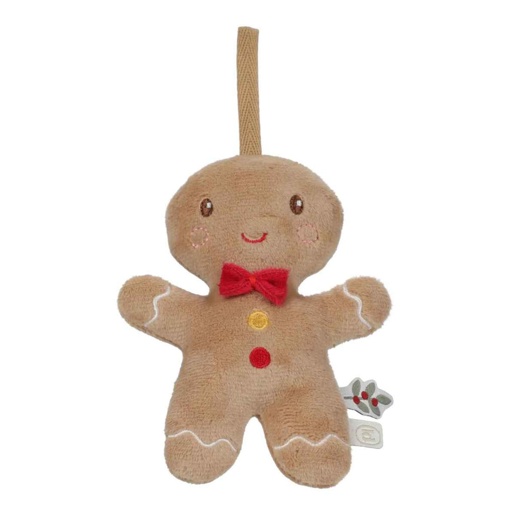 Stuffed gingerbread man toy with a red bow tie on a white background