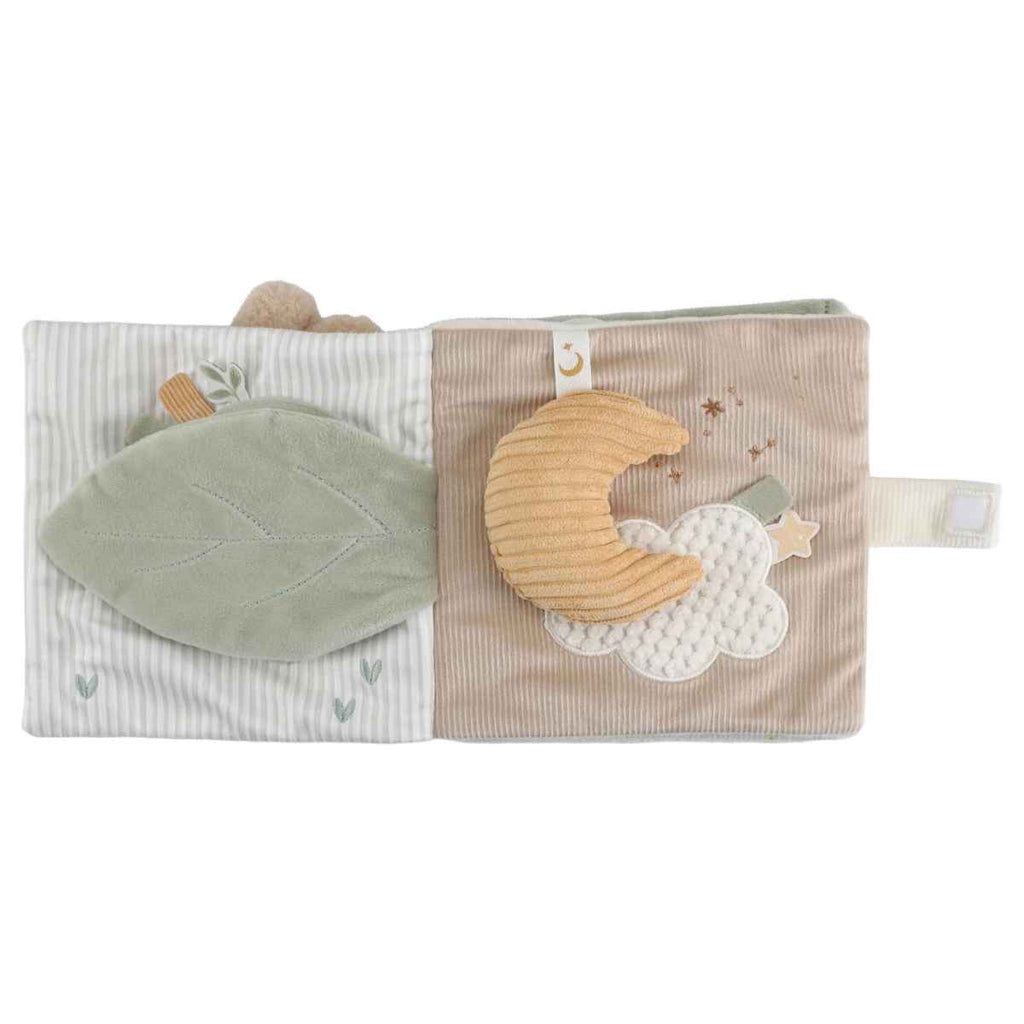 A soft toy made in the shape of a moon with a cloud on the page behind.