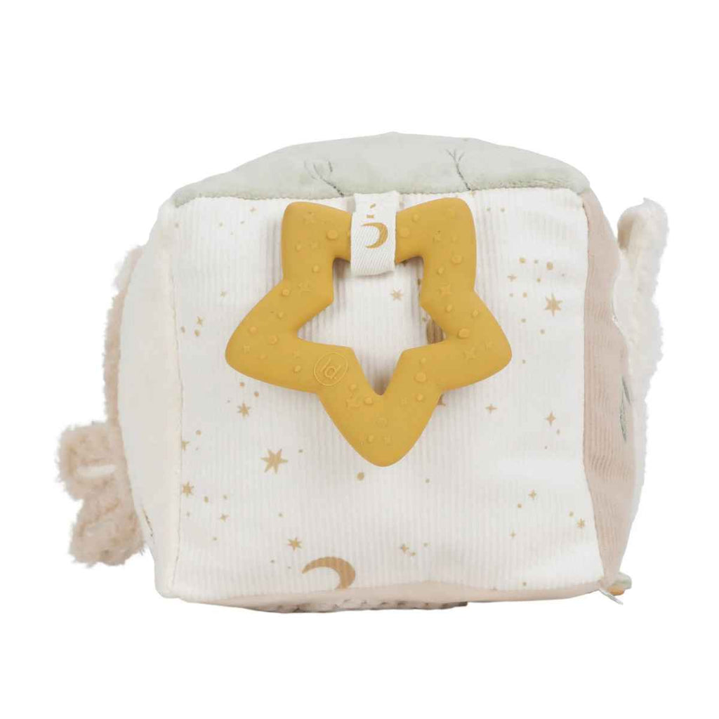 Soft activity cube with a yellow star-shaped teether on a white background
