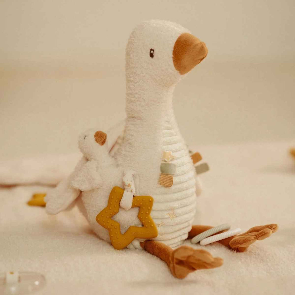 Activity goose with star shaped teether and baby goose on a soft background