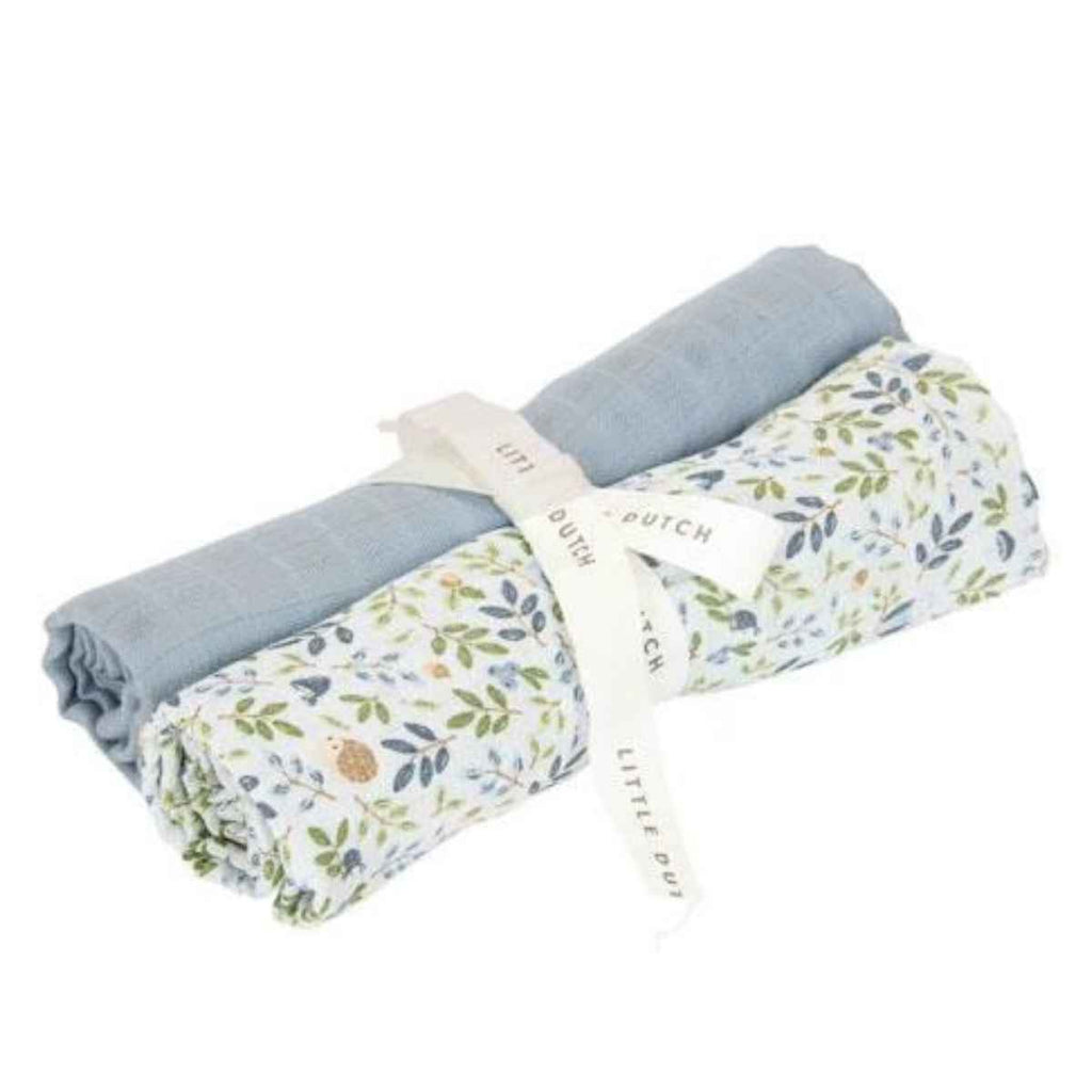 Two rolled-up baby swaddles, one blue and one with floral pattern, on a white background.