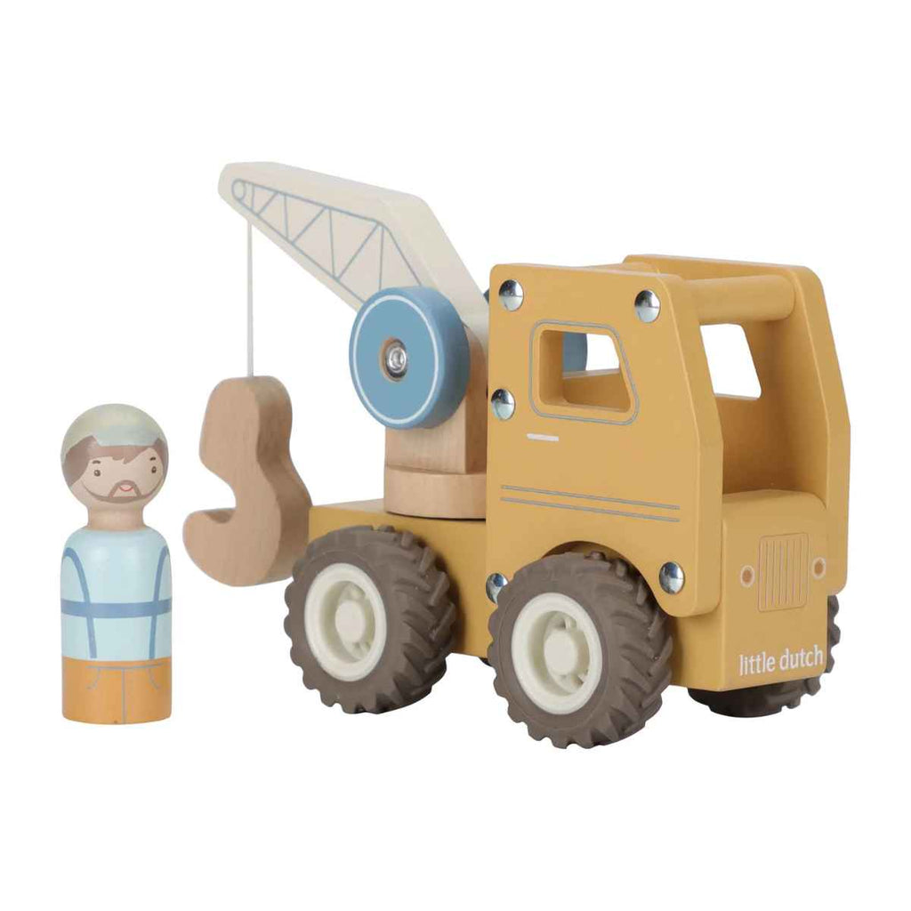 Wooden yellow toy crane with a small figure next to it on a white background