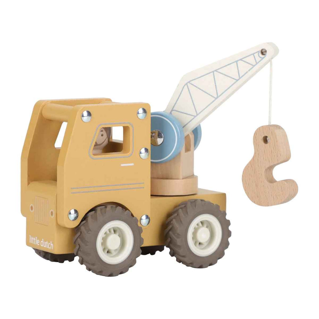 Toy crane with a yellow truck body and white crane arm on a white background