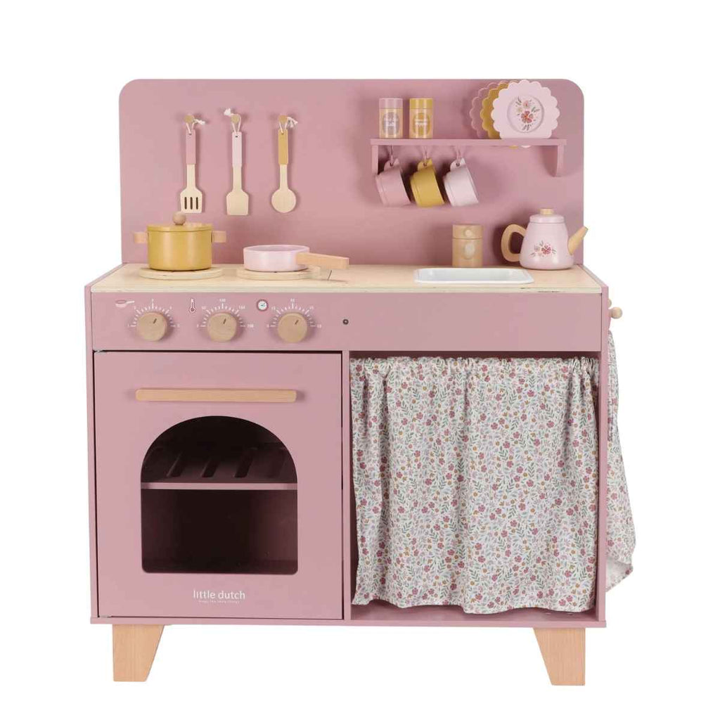 Pink toy kitchen set with various accessories on a white background