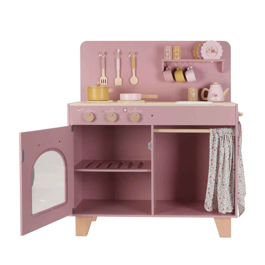 Pink toy kitchen set open with various accessories on a white background
