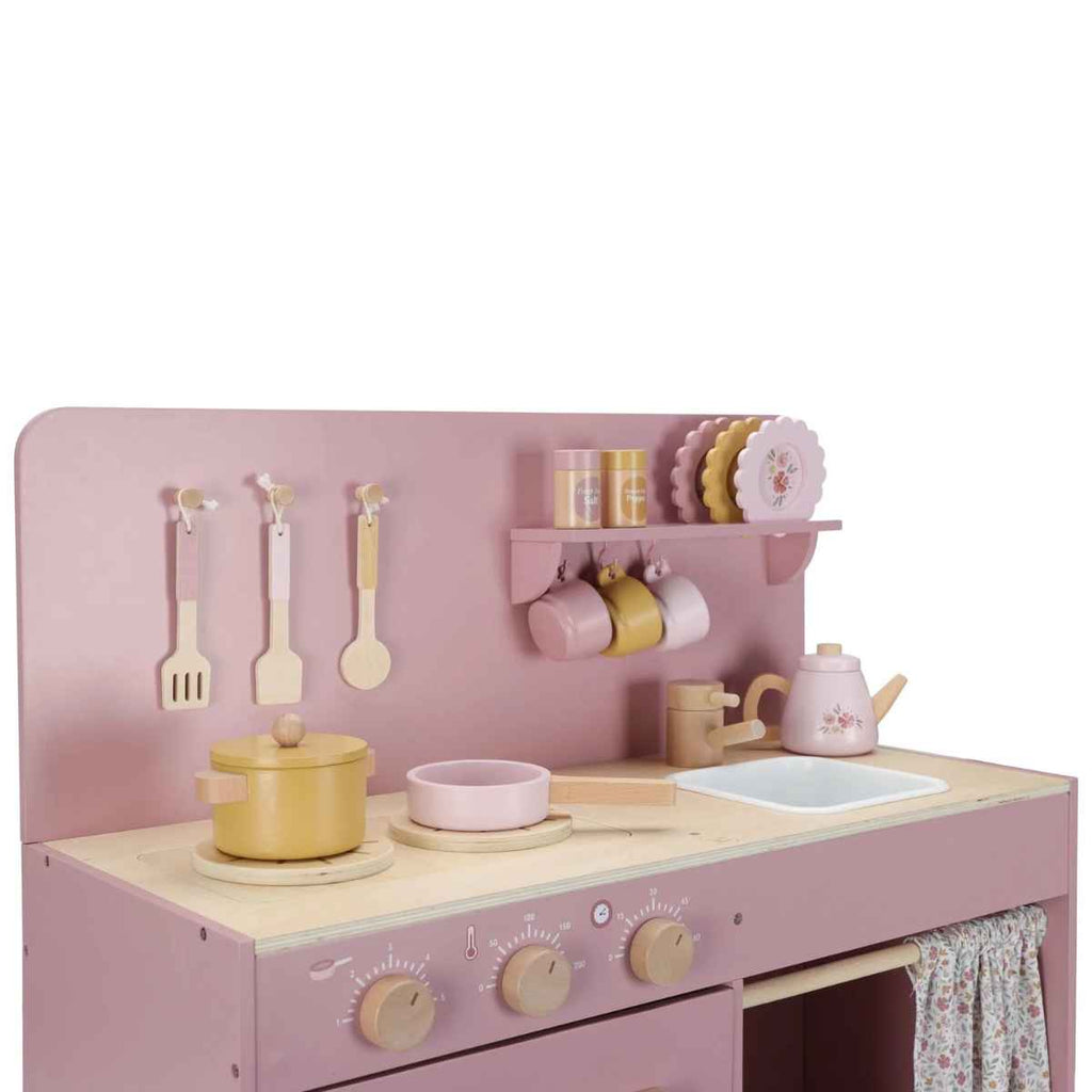 Children's pink play kitchen set with utensils and accessories on a white background