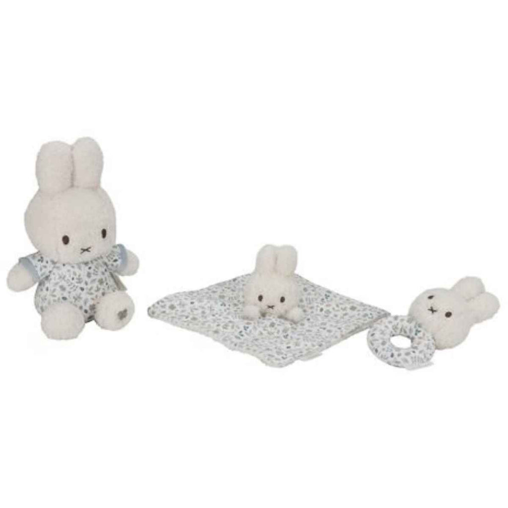 Set of baby toys including a plush bunny, cuddle cloth, and rattle on a white background