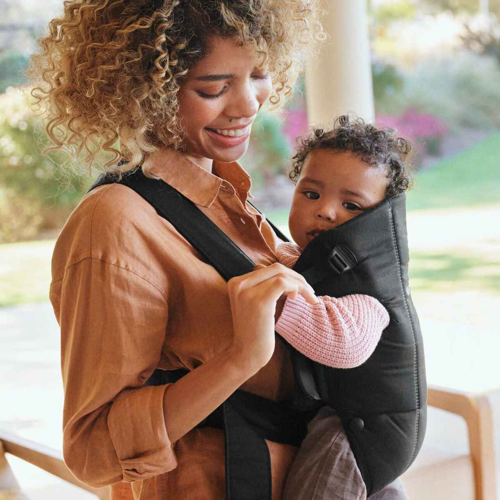 BabyBjörn | Woman Holding Baby In Baby Carrier Mini | ChocoLoons