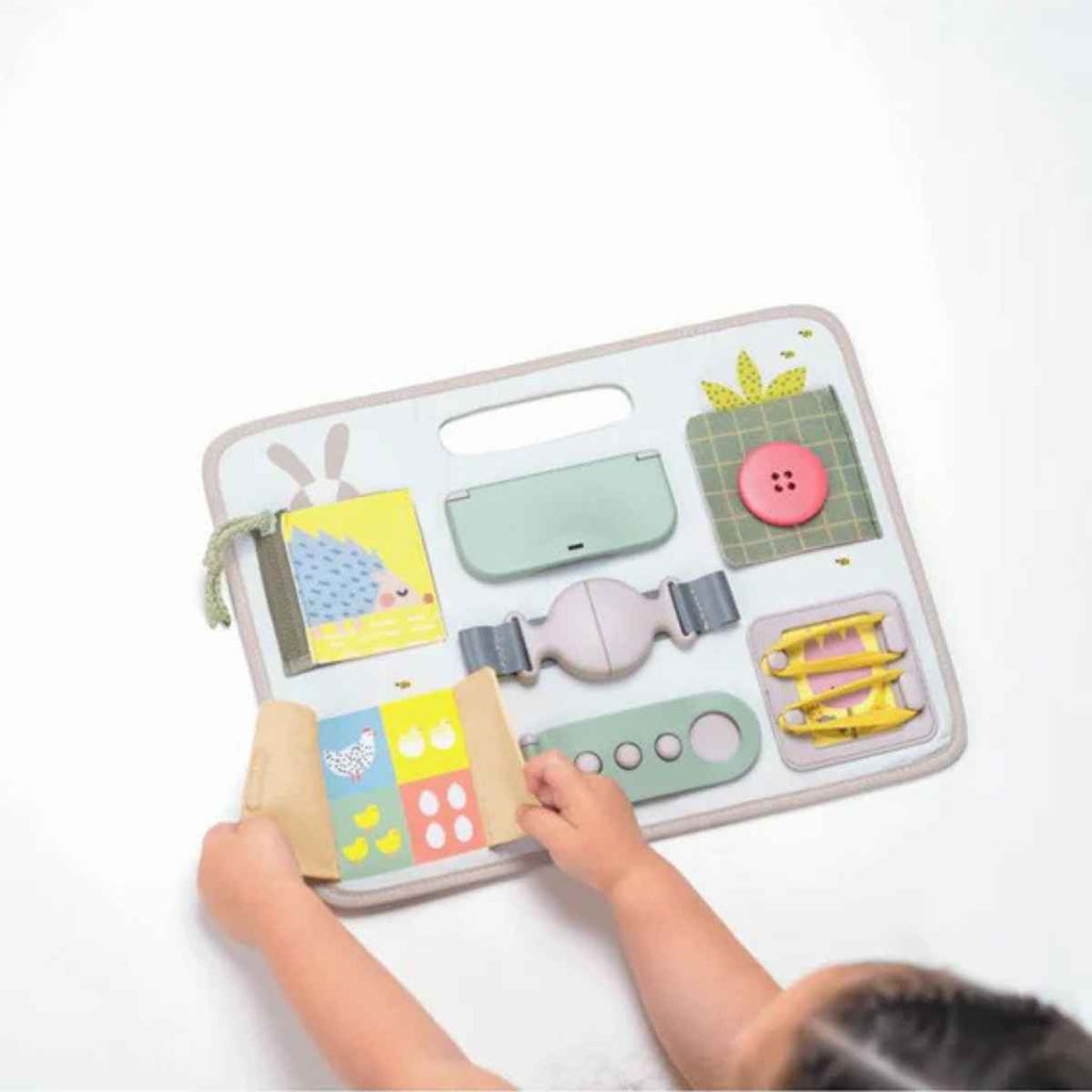 Taf Toys | Child Playing With Activity Buckles Board | ChocoLoons