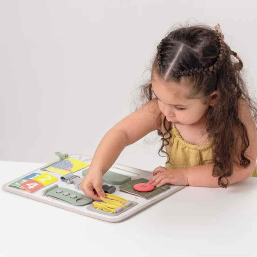 Taf Toys | Girl Using Buckle Board | ChocoLoons