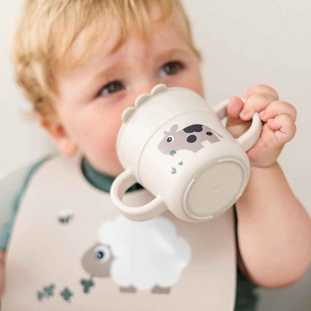 Done by Deer | Child Drinking From Foodie Spout Cup | Tiny Farm | Sand | ChocoLoons