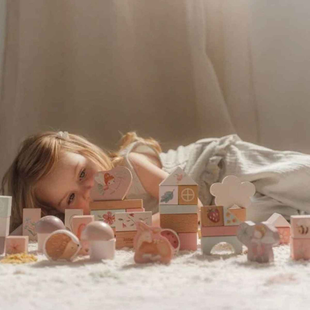Little Dutch | Girl Laying Beside Building Blocks | ChocoLoons