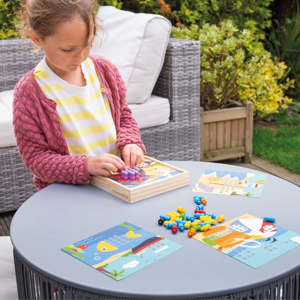 Girl Playing With The Seaside Peg Board Game | Chocoloons