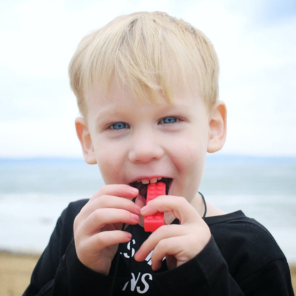 Boy Using A Red Brick Stick Necklace | Sensory Oral Chew | Chocoloons
