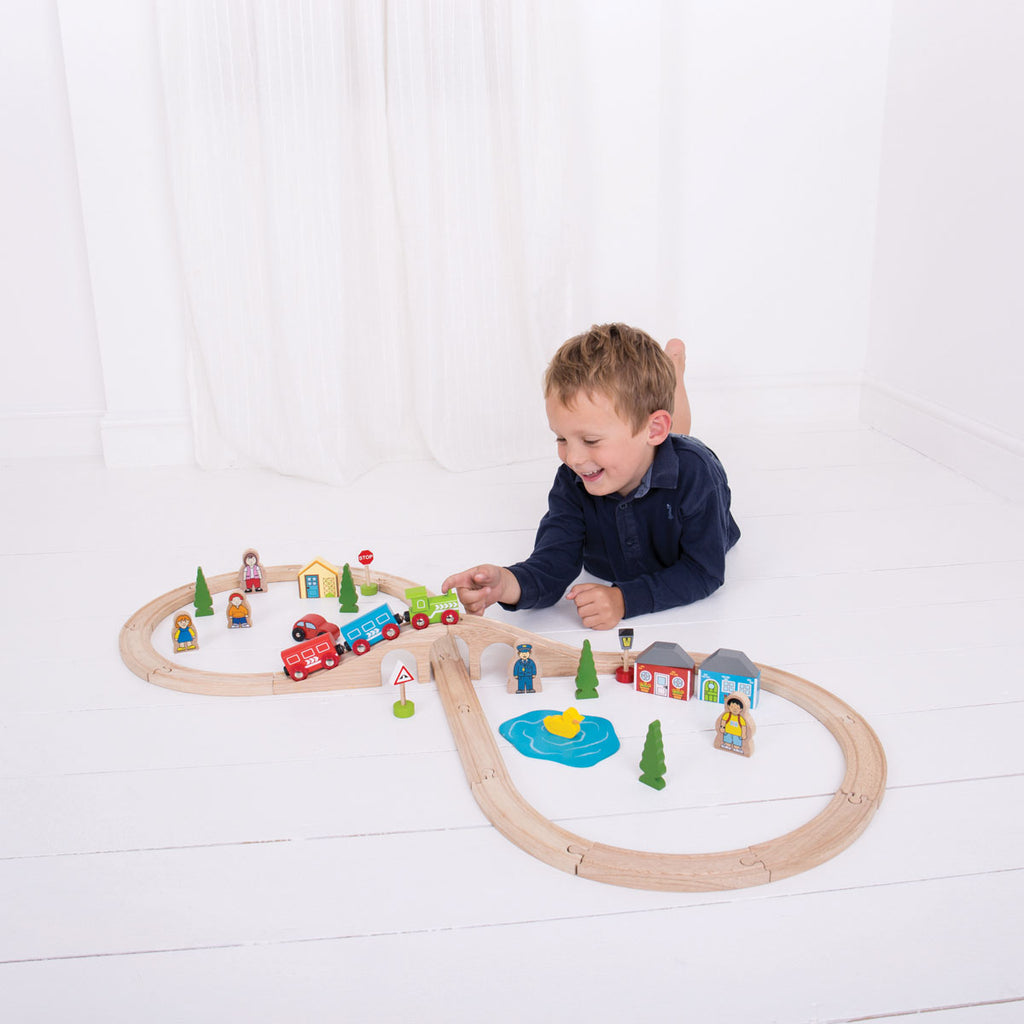 Boy Playing With Figure of Eight Wooden Train Set | Chocoloons