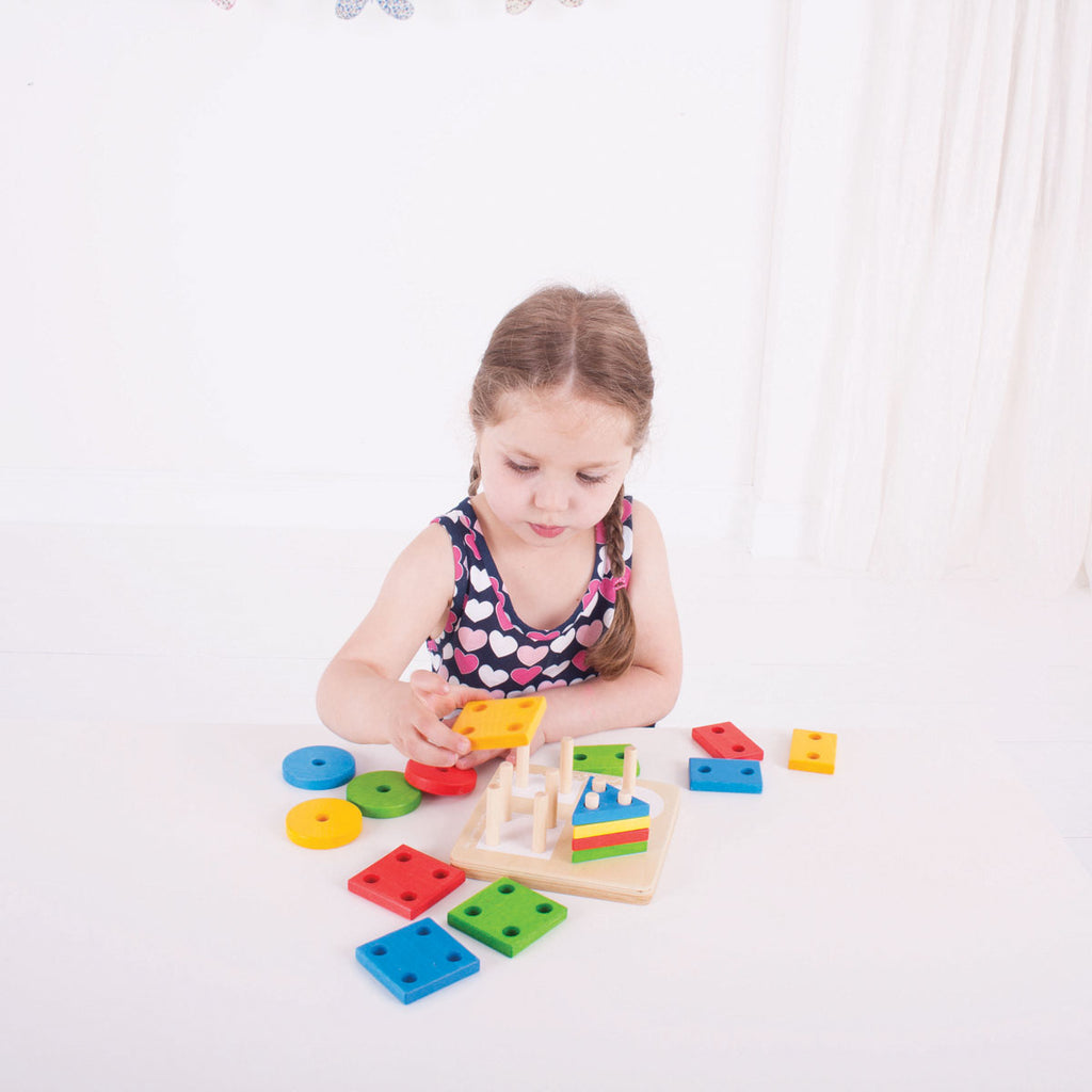 Girl Playing With Bigjigs Wooden Four Shape Sorter | Chocoloons