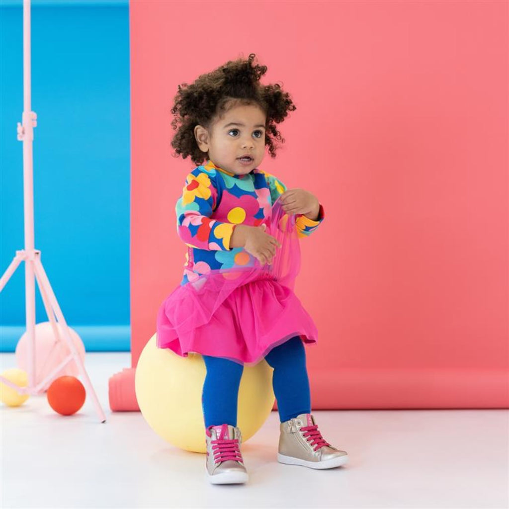 Agatha Ruiz De La Prada | Girl Wearing A Long Sleeve Flower Top, Pink Netted Skirt And Blue Tights | Chocoloons