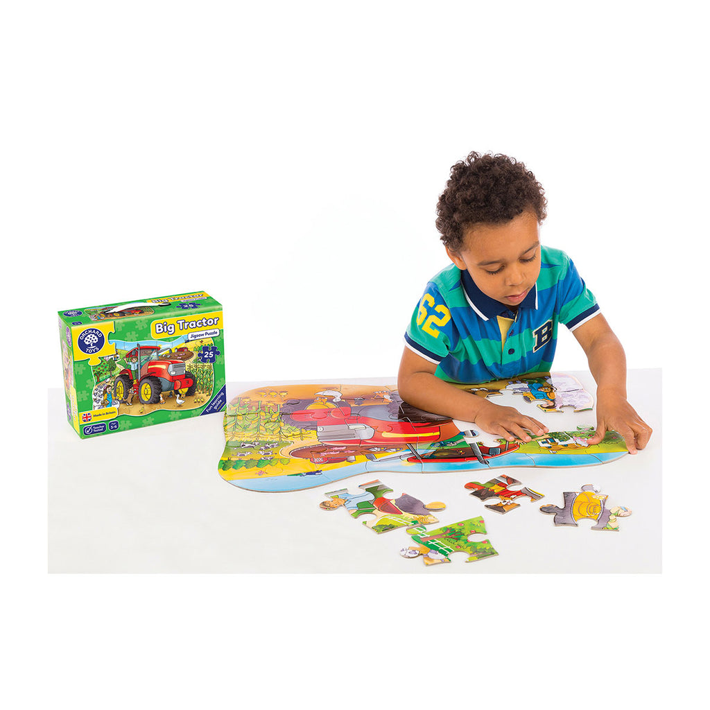 Boy putting the pieces together of his Orchard Toys Big Tractor Jigsaw | Chocoloons